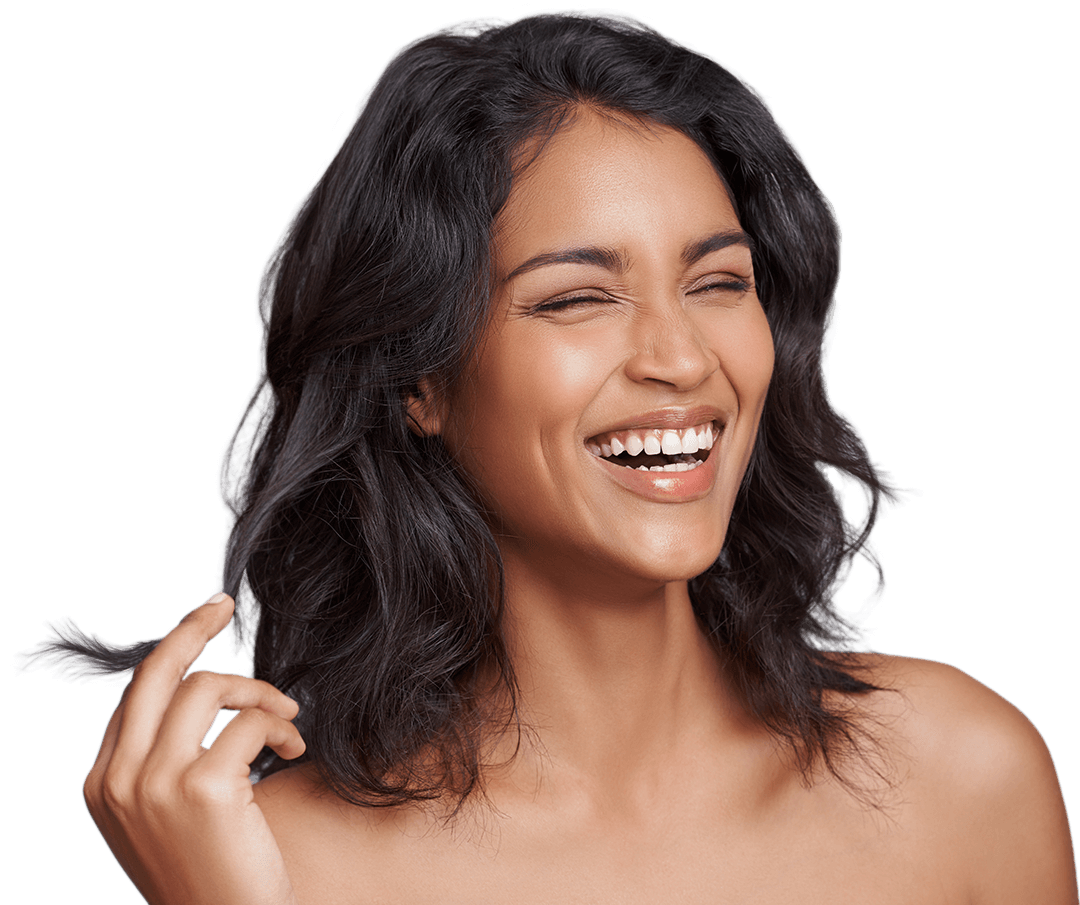 woman smiling brightly as she twirls her hair in her fingers